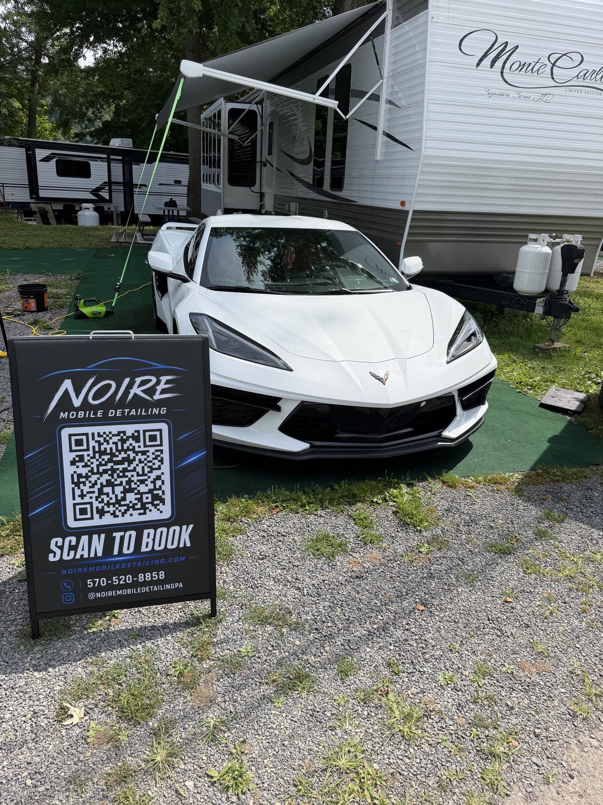 White Corvette detailed by Noire Mobile Detailing with a scan to book sign